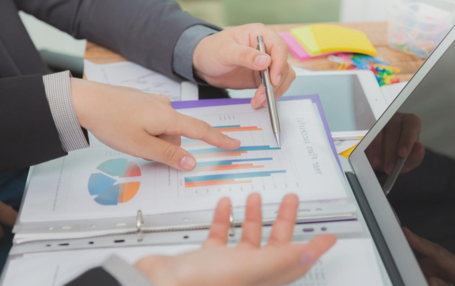 Professional budget consultation workspace with financial analytics and strategic planning materials